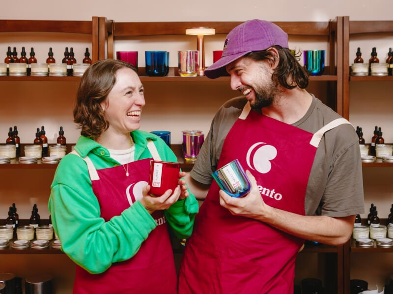 People smiling at each other, holding their candles